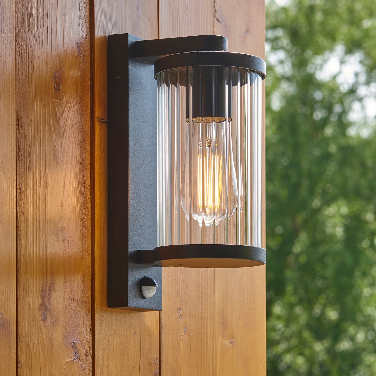 Outdoor Wall Light with Integrated PIR in Black with Ribbed Glass - ID 13968